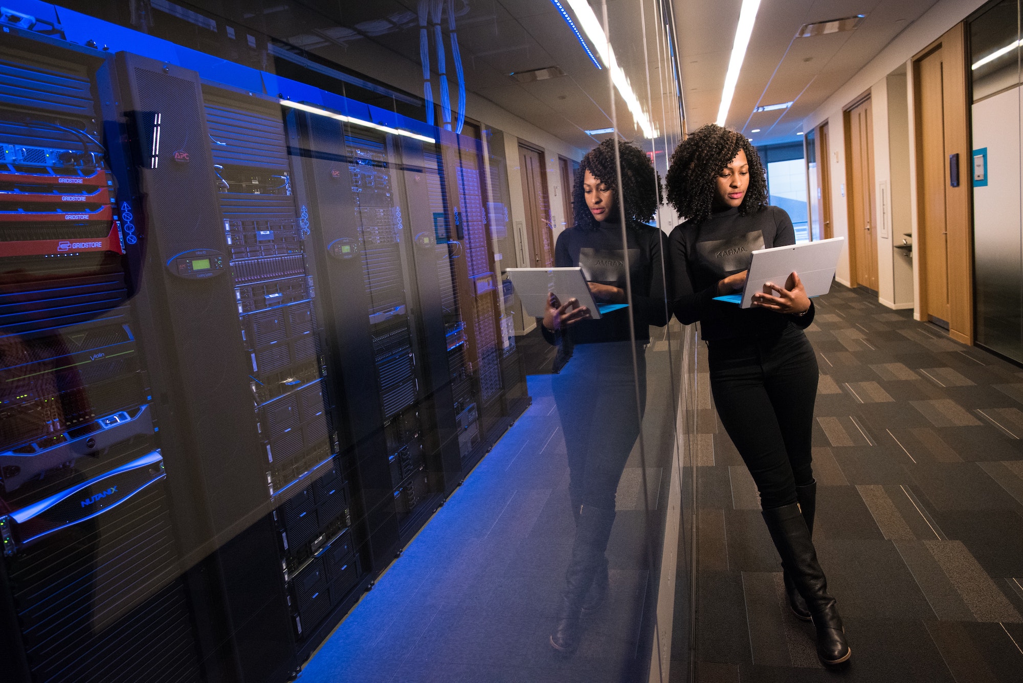 Woman standing by servers